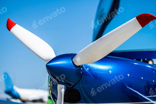 Preview: Closeup view of white propeller of the blue sport plane nose