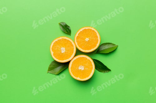 Preview: Fruit pattern of fresh orange slices on colored background. Top view. Copy Space