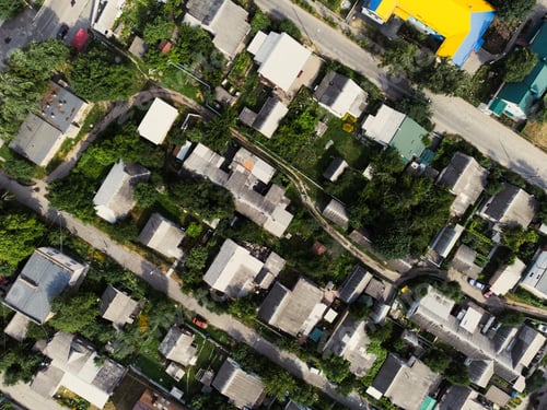 Preview: Aerial view of suburb of European city. Green neighbourhood on a sunny summer day. County living