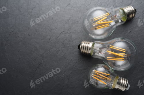 Preview: Transparent LED filament light bulbs on black background.