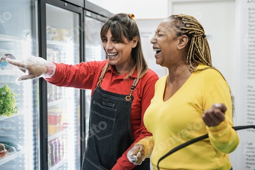 Preview: Supermarket female employee helping a customer to choose