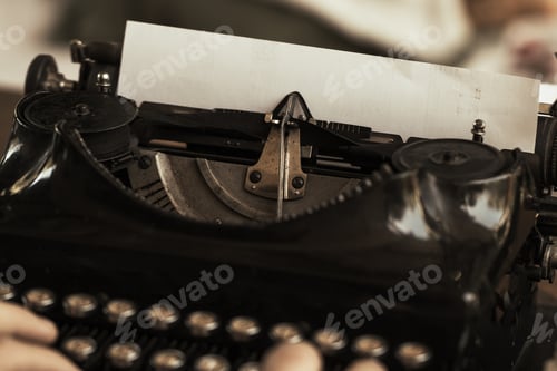 Preview: Young man's hands typing on an antique vintage typewriter