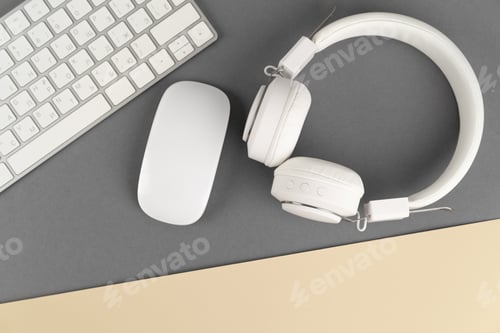 Preview: Music and podcasts, white headphones and keyboard on a grey background, notebook with pencil, mocap