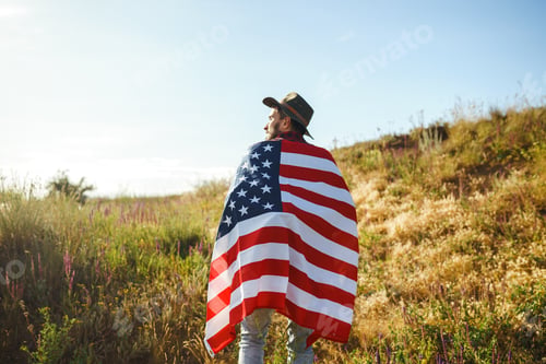 Preview: 4th of July. American Flag.Patriotic holiday. Traveler with flag of America. Beautiful sunset light.