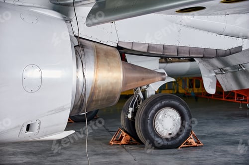 Preview: aircraft engine servicing - opened panels of a large engine of parked aircraft.