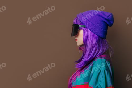 Preview: Stylish woman in sunglasses and purple clothes and hair on brown background