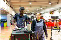 Preview: Mechanics working in busy auto repair shop