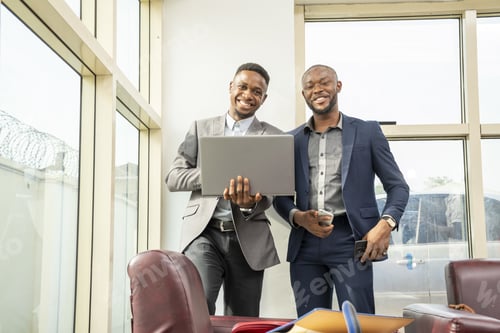 Preview: Young black businessmen standing together smiling