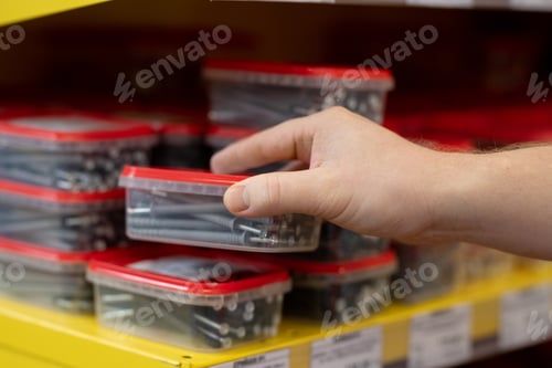 Preview: Hand of male taking container with nails