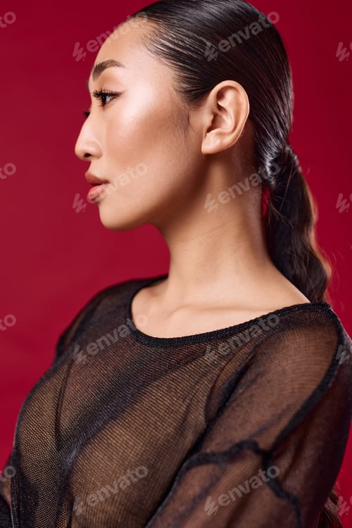 Preview: Woman's Profile with Sleek Hair Against Red