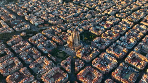 Preview: Aerial view of Barcelona Eixample residential district and Sagrada Familia Basilica at sunrise