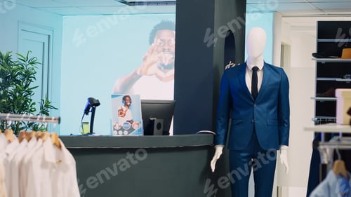 Preview: Modern fashionable shop with clothes on hangers