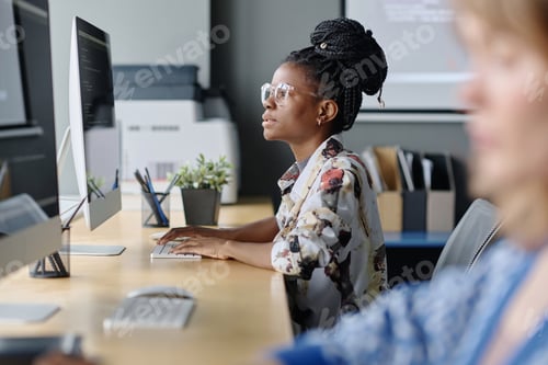 Preview: Black Female Coder Typing on Office Computer