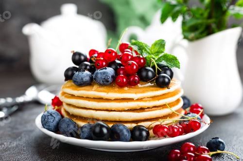 Preview: Pancakes with fresh berries. Pancakes with raspberry, blueberry, redcurrant, black currant and honey