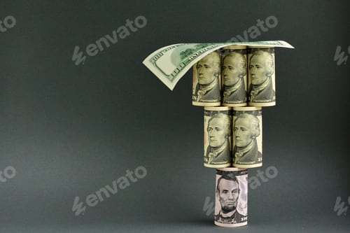 Preview: Rolled up dollar bills in the shape of pyramid. Finance, exchange rate, currency, economy concept.