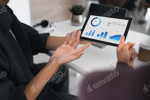 Preview: Business partnership coworkers using a tablet to analysis financial budget report and cost work