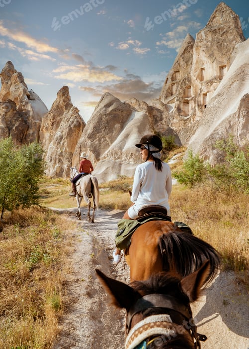 Preview: young woman on a horse back during vacation in Turkey Kapadokya watching Cappadocia