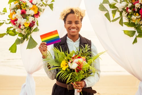 Preview: african american female groom in black suit and happy caucasian blonde