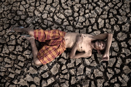 Preview: Elderly men lay flat on their hands, on the stomach and forehead, on dry soil, global warming.