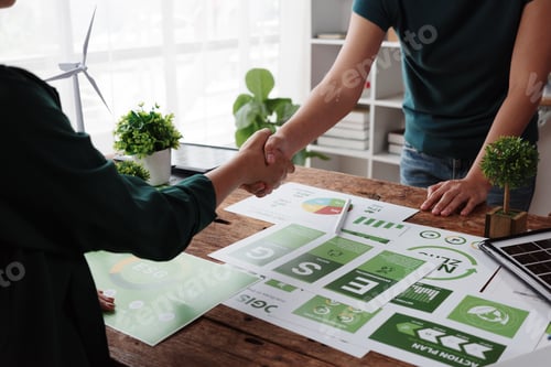 Preview: Business people shaking hands over ESG documents, promoting sustainable business practices