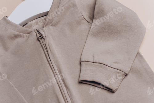 Preview: Close Up of Baby Clothes on Hanger