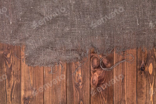 Preview: Burlap on wooden table background, top view