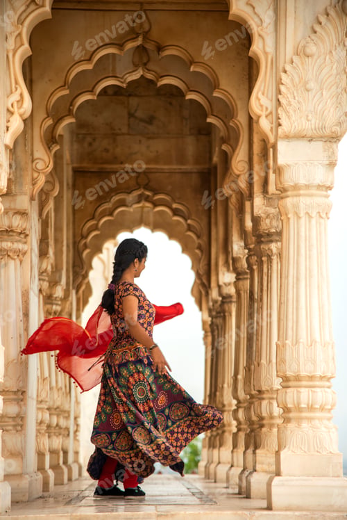 Preview: Young female tourist dancing between arches and Pillars.