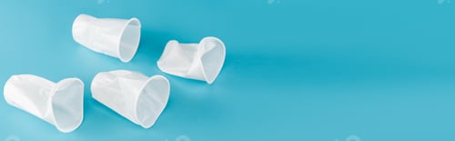 Preview: disposable plastic crumpled cups on blue background, panoramic shot
