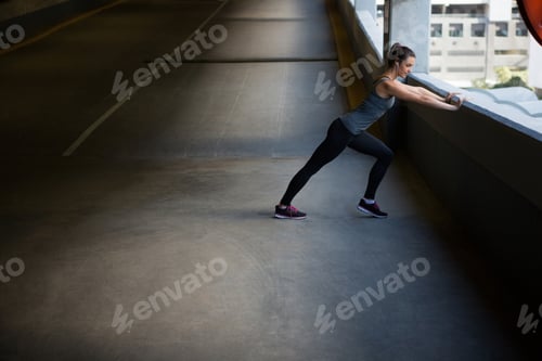 Preview: Fit woman doing stretching exercise