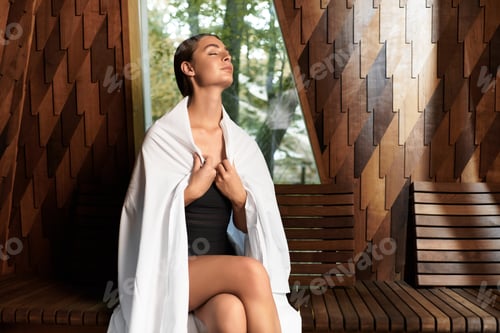 Preview: Young woman finds peace in a modern wellness center sauna retreat