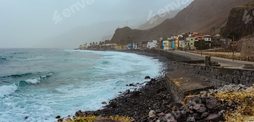 Preview: Panoramic view of rough ocean waves with blowing spray rolling onto the rocky volcanic coastline