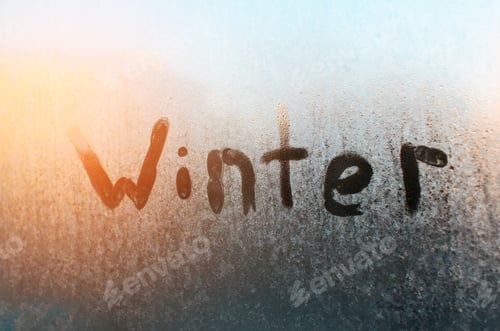 Preview: Winter text on frozen window. Frosty pattern on glass, sunny morning. Sunshine