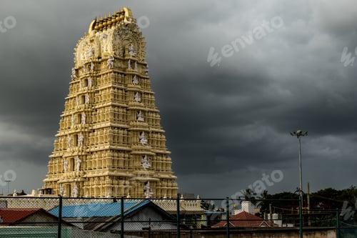 Preview: Beautiful gopuram of Chamundeshwari Temple against the sky with black clouds in Mysore, India