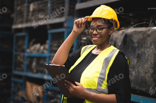 Preview: black African woman worker work in metal heavy industry machine factory as engineer team standing