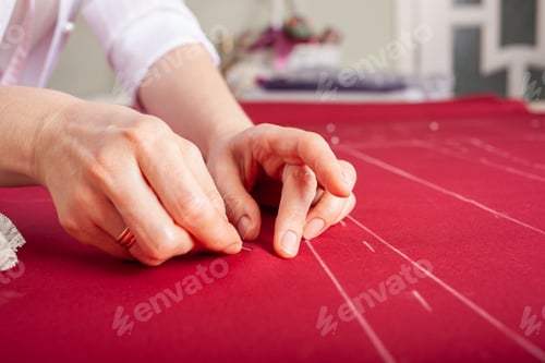 Preview: The master seamstress rocks two parts of the fabric with pins