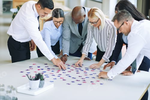 Preview: Diverse group of businesspeople solving a puzzle in an office