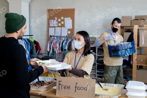 Preview: A group of people giving free food in a room