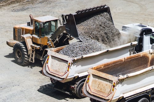 Preview: wheel loader working on construction site and loading gravel on dumper trucks.