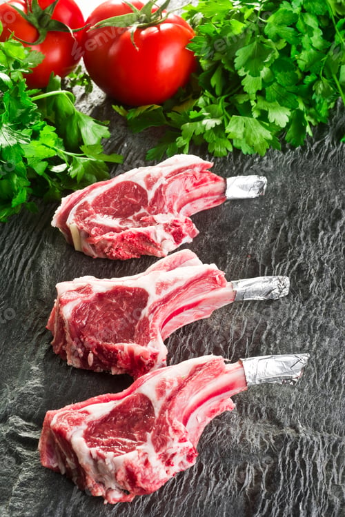 Preview: Raw meat ribs on a black stone plate