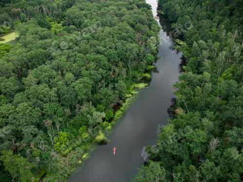 Preview: aerial view of a group of kayaks traveling on a forest river on a summer day