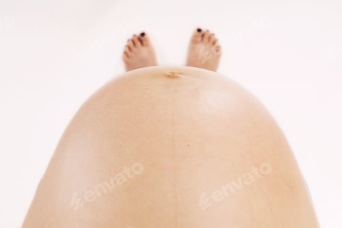 Preview: Top view to pregnant belly. Woman, future mother