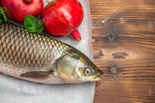 Preview: top view fresh fish with pomegranates on brown wooden desk ocean food sea seafood