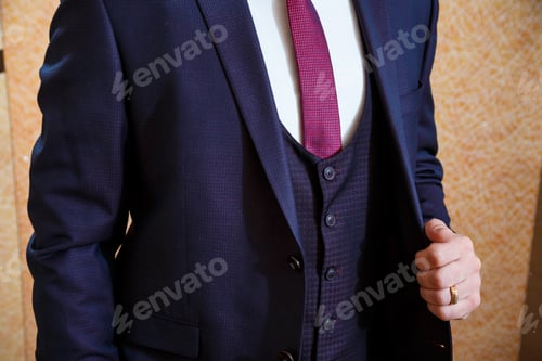 Preview: A man puts on a men's suit on the day of the wedding