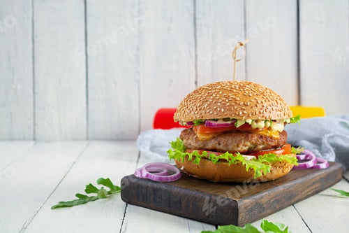 Preview: Homemade classic hamburger with beef cutlet, cheese, lettuce and tomato on wooden background