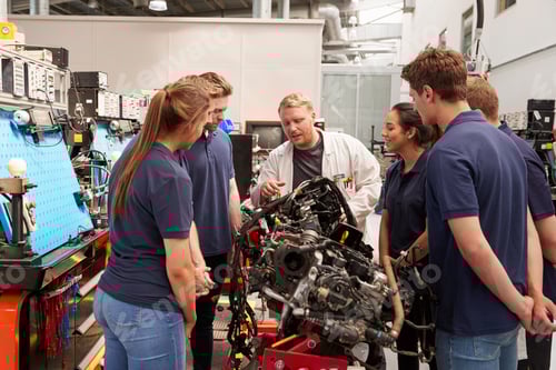 Preview: Car mechanic showing engines to apprentices
