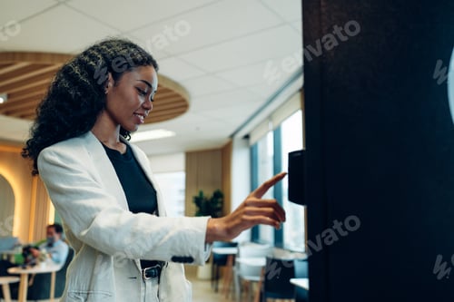 Preview: woman's finger pushing number button on keyboard of snack vending machine.