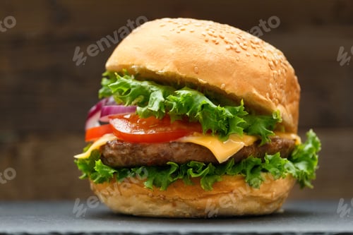 Preview: Juicy appetizing burger with beef on a dark background, homemade hamburger, fast food.