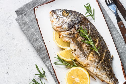 Preview: Baked dorado fish with lemon and rosemary top view