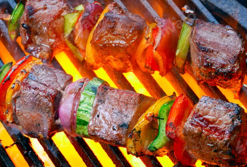 Preview: Steak barbeque sizzling over an open flame