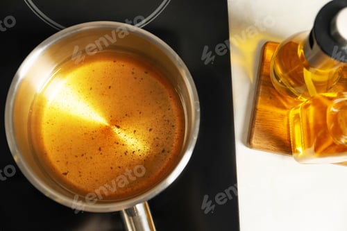 Preview: Used cooking oil in saute pan on stove, above view